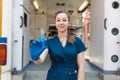 Young professional nurse in medical uniform, show syringe in her hands at ambulance background Royalty Free Stock Photo