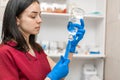 Young professional nurse in medical uniform, show syringe in her hands at ambulance background Royalty Free Stock Photo