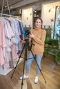 Young photographer using a tripod while working Royalty Free Stock Photo