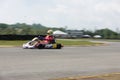 Young professional racer with competing with his go-kart in a competition