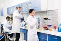 Young professional scientists making experiment in research laboratory Royalty Free Stock Photo