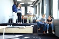 Young professional team. Group of young modern people in smart casual wear standing in the creative office Royalty Free Stock Photo