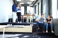 Young professional team. Group of young modern people in smart casual wear standing in the creative office