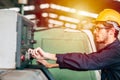 Young professional technician engineer operate the machine to automated CNC in heavy industrial factory Royalty Free Stock Photo