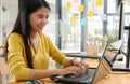 Young professional woman uses a laptop for work and online meetings, she works from home