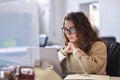 Young professional woman using laptop watching online webinar at work. Royalty Free Stock Photo