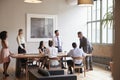 Young professionals around a table at a business meeting Royalty Free Stock Photo