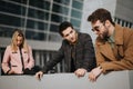 Young professionals engaged in a strategic marketing meeting outdoors Royalty Free Stock Photo