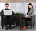 Young professionals in office lobby with laptop