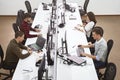Young professionals working in modern office. Group of developers or programmers sitting at desks focused on computers