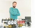 Young programmer adjusting cryptocurrency mining rig to optimal operational settings Royalty Free Stock Photo