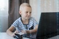 Young programmer writing code on a computer at home. Programming lessons for kids. Royalty Free Stock Photo