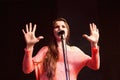 Young protesting woman on stage with microphone