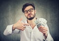 Overconfident man with pile of money