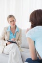 Young psychologist attentively listening to her patient Royalty Free Stock Photo