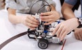 Young pupils creating electronic robot at school