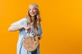 Young puzzled woman wearing bandanna using cellphone