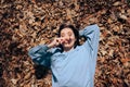 Funny Woman Sitting on Dry Autumn Leaves