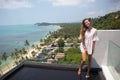 The young quite stylish sensual woman posing on the amazing tropical beach with the blue ocean enjoy her holiday and a windy summe Royalty Free Stock Photo