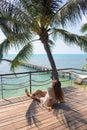 The young quite stylish sensual woman posing on the amazing tropical beach with the blue ocean enjoy her holiday and a windy summe Royalty Free Stock Photo