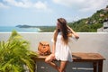 The young quite stylish sensual woman posing on the amazing tropical beach with the blue ocean enjoy her holiday and a windy summe Royalty Free Stock Photo