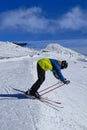 Young racer prepares for his first race. Set. Ready. Go. Skier have to stands on start line and prepare skis for a ride. Freerider