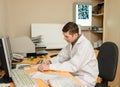 Young radiologist doctor analyses the digital x ray on the computer