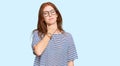Young read head woman wearing casual clothes and glasses touching painful neck, sore throat for flu, clod and infection