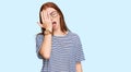 Young read head woman wearing casual clothes and glasses yawning tired covering half face, eye and mouth with hand Royalty Free Stock Photo