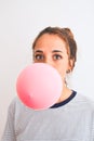 Young readhead modern woman chewing gum and doing air bubble Royalty Free Stock Photo