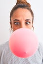 Young readhead modern woman chewing gum and doing air bubble Royalty Free Stock Photo