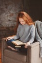 Young readhead student woman learning and reading books