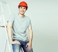 young real hard worker man isolated on white background on ladde Royalty Free Stock Photo