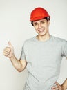 Young real hard worker man isolated on white background on ladder smiling posing, business concept Royalty Free Stock Photo