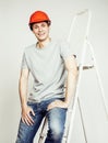 Young real hard worker man isolated on white background on ladder smiling posing, business concept Royalty Free Stock Photo