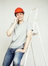 Young real hard worker man isolated on white background on ladder smiling posing, business concept Royalty Free Stock Photo