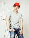 Young real hard worker man isolated on white background on ladder smiling posing, business concept Royalty Free Stock Photo