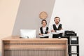 Young receptionists in professional uniform