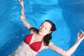 Young Red Bikini Female In Swimming in Pool Royalty Free Stock Photo