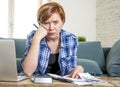 Young red hair Caucasian woman around 30 years old working paperwork domestic finance accounting and banking looking depressed Royalty Free Stock Photo