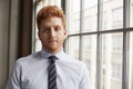 Young red haired bearded businessman looking to camera Royalty Free Stock Photo