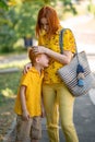 A young red-haired boy crying near his mother. Childish disappointment, tears. Parent support Royalty Free Stock Photo