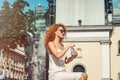 Young red haired girl drinking a bottle of water.