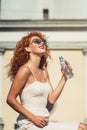 Young red haired girl drinking a bottle of water. Royalty Free Stock Photo