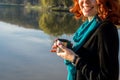 Young red-haired girl holding in her hands a cup Royalty Free Stock Photo