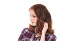 Young red-haired girl in a plaid shirt looks away. Royalty Free Stock Photo