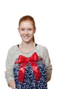 Young red haired Girl presenting a gift