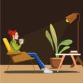 young red-haired girl sits on a chair, drinks coffee and rests from a hard day