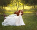 A young, red-haired princess in a crystal tiara, hugs and strokes her horse. The background is a fantastic forest glade