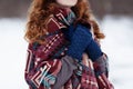 Young red-haired woman in blue headphones and gloves